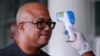 Dr. Chikwe Ihekweazu, the Director General of the Nigeria Centre for Disease Control (NCDC) has his temperature checked during a diplomatic meeting at the Ministry of Foreign Affairs in Abuja, Nigeria on March 12, 2020. 