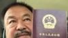 FILE - This handout picture released by Chinese dissident artist Ai Weiwei on July 22, 2015, shows him posing with his passport in Beijing. 