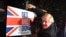 Britain's Prime Minister and Conservative party leader Boris Johnson poses as he hammers a "Get Brexit Done" sign into the garden of a supporter, in Benfleet, east of London on Dec. 11, 2019, the final day of campaigning for the general election. 