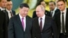 FILE - President Vladimir Putin, right, and President Xi Jinping enter a hall for the talks in the Kremlin in Moscow, Russia, June 5, 2019.