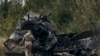 A Ukrainian soldier passes by a Russian tank damaged in a battle in a just freed territory on the road to Balakleya in the Kharkiv region, Ukraine, Sunday, Sept. 11, 2022. (AP Photo)