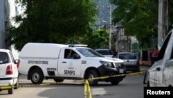 A Forensic Medical Service vehicle is seen behind barricade tape at the crime scene, following the death of Mexican journalist Nelson Matus, in Acapulco, Mexico July 15, 2023 in this handout image.