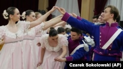 Dancers of the WARSZAWIANKA ensemble of the University of Warsaw dance Poland's national polonaise dance in 18th century costumes during dress rehearsal in Warsaw, Poland, on Feb. 8, 2024. (AP Photo/Czarek Sokolowski)