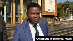 Tinashe Chinopfukutwa from Zimbabwe Lawyers for Human Rights talks to reporters about his clients outside Harare Magistrates Court in Zimbabwe, on June 18, 2024.