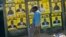 A boy leans near to campaign posters with images of candidates in Harare, Zimbabwe, on July 16, 2023.