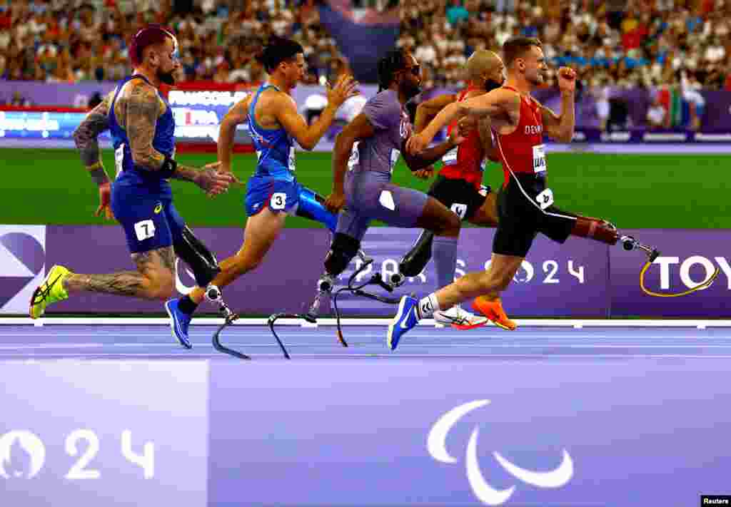 Athletes compete in the men's 100m athletics T63 round 1 at the Stade de France in Sait-Denis, during the Paris 2024 Paralympics, Sept. 1, 2024.
