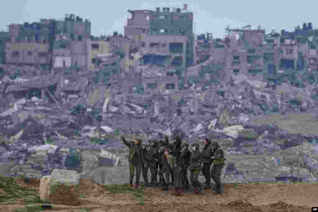 Israeli female soldiers pose for a photo on a position on the Gaza Strip border, in southern Israel, Feb. 19, 2024.