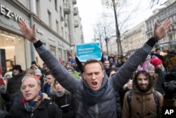 FILE - Russian opposition leader Alexei Navalny, center, attends a rally in Moscow, Russia, on Jan. 28, 2018. (AP Photo/Evgeny Feldman, File)