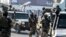 FILE - Afghan security personnel arrive at the Kabul airport in Kabul, Feb. 12, 2024. The Taliban government confirmed, March 31, 2024, they had detained 'a number of foreign citizens, including two Americans' for allegedly violating their laws. 