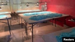 FILE - Blue powder is pictured over tables at a fentanyl pill manufacturing center and a methamphetamine lab seized by the Mexican army, in Culiacan, in Sinaloa state, Mexico, Feb. 14, 2023.