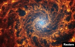 Spiral galaxy NGC 628, located 32 million light-years away from Earth, is seen in an undated image from the James Webb Space Telescope. (NASA, ESA, CSA, STScI, Janice Lee (STScI), Thomas Williams (Oxford), and the PHANGS team/Handout via REUTERS)