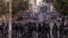 FILE - Senegalese Gendarmerie block a road after protests burned tires and blocked roads in Dakar, June 3, 2023. 