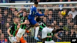 FILE - Chelsea's Levi Colwill, top center, scores a goal during a soccer match between Chelsea and Brighton and Hove Albion, at Stamford Bridge stadium in London on Dec. 3, 2023. (AP Photo/Alastair Grant)