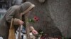 A woman pays tribute to Alexey Navalny at the monument where the first camp of the Gulag political prison system was established in St. Petersburg, Russia, Feb. 21, 2024. Navalny, the most famous Russian opposition leader, died in prison Feb. 16, at 47.