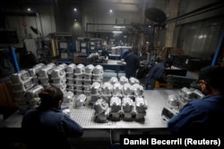 People work at the Pace Industries aluminum injection molding plant, company that recruits migrant asylum seekers through a UNHCR refugee program, in Saltillo, Mexico October 16, 2023. (REUTERS/Daniel Becerril)