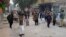 Security personnel and people gather near the site of a bomb explosion at Sibi, in Baluchistan province, Jan. 30, 2024. 