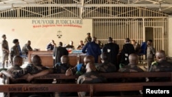 FILE - Members of the Congolese army, sentenced to death for desertion and cowardice when fighting M23 rebels, sit inside a military courtroom during their trial in Goma, North Kivu province, Democratic Republic of Congo, May 3, 2024.