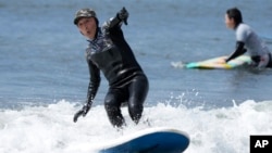 Seiichi Sano, an 89-year-old Japanese man, rides a wave at Katase Nishihama Beach, Thursday, March 30, 2023, in Fujisawa, south of Tokyo. Sano, who turns 90 later this year, has been recognized by the Guinness World Records as the oldest male to surf. (AP Photo/Eugene Hoshiko)