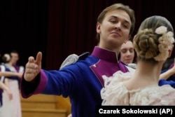 Dancers of the University of Warsaw dance Poland's national polonaise dance in 18th century costumes during dress rehearsal in Warsaw, Poland, on Feb. 8, 2024. (AP Photo/Czarek Sokolowski)
