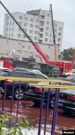 中国黑龙江救援人员在齐齐哈尔中学体育馆房顶塌陷后展开搜救行动。（2023年7月24日）