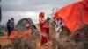 FILE - A Somali woman breastfeeds her child at a camp for displaced people on the outskirts of Dollow, Somalia, on Sept. 20, 2022. A new report estimates 43,000 people died amid Somalia's drought last year, half of them children.