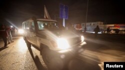 A Red Cross vehicle carrying hostages abducted by Hamas militants during the October 7 attack on Israel arrives at Rafah border, amid a hostages-prisoners swap deal between Hamas and Israel, in southern Gaza Strip, Nov. 28, 2023. 