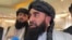 FILE - Zabihullah Mujahid, chief Taliban spokesperson, talks with reporters in Doha, Qatar, June 30, 2024.