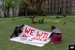 FILE - Demonstrators open a sign after removing their encampment protesting the Israel-Hamas at Brown University, Tuesday, April 30, 2024, in Providence, R.I. (AP Photo/David Goldman)