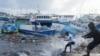 Nelayan menarik perahu yang rusak akibat Badai Beryl kembali ke dermaga di Bridgetown Fisheries di Barbados, Senin, 1 Juli 2024. (AP Photo/Ricardo Mazalan)