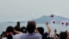 25일 한국 전라남도 고흥군 나로우주센터에서 '누리호' 3차 발사 직후 시민들이 태극기를 흔들며 환호하고 있다. 