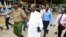 Detectives escort Ezekiel Ombok Odero, head of New Life Prayer Centre/Church in Kilifi County, at the police headquarters for investigations into deaths linked to another Christian cult, in Mombassa, Kenya, April 27, 2023.