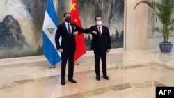 2021年12月10日尼加拉瓜贸易和国际合作顾问劳雷亚诺·奥尔特加·穆里略(左)在天津会晤时任中国外交部副部长马朝旭