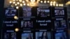 Pictures of the dead, missing and those taken hostage are displayed beside candles during the Jewish Community Vigil for Israel in London, Britain, Oct. 9, 2023.
