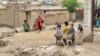 Children are seen gathered in a flood-damaged courtyard following heavy rains, in Kar Kar village, Baghlan province, Afghanistan, May 11, 2024.