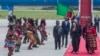 U.S. Vice President Kamala Harris, second right, is greeted by traditional dancers after landing in Lusaka, Zambia, March 31, 2023.