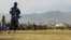 FILE - Taliban security personnel stand guard as people watch a public flogging at a stadium in Charikar, Parwan province, Afghanistan, on Dec. 8, 2022. Four people, including a woman, were similarly flogged recently, Taliban officials said on Oct. 29, 2024.