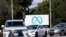 Cars drive past a Meta sign outside of the company's headquarters in Menlo Park, Calif., March 7, 2023.
