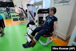 Yasuko Kuroi, 72, uses a leg extension machine as she works out at the Fukagawa Sports Center in Tokyo, Wednesday, June 12, 2024. If you are getting up there in years, weight-resistance training might deliver unexpected benefits. (AP Photo/Hiro Komae)