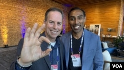 Alex Luebke, Vivek Kumbhari and the PillBot are pictured at the TED Conference in Vancouver, British Columbia, which was held April 15-19, 2024. (Craig McCulloch/VOA)