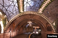 FILE - Chandeliers, vaulted tile ceilings and skylights are evident as a train comes through the City Hall Station in New York City. (Photo by Patrick Cashin, MTA New York City Transit)
