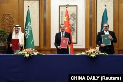 中共中央外办主任王毅与伊朗最高国家安全委员会秘书阿里·沙姆哈尼（右）同沙特国务大臣、内阁成员和国家安全顾问穆萨伊德·本·穆罕默德·艾班在北京举行会谈。（2023年3月10日）