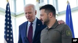 US President Joe Biden walks with Ukrainian President Volodymyr Zelenskyy ahead of a working session on Ukraine during the G7 Summit in Hiroshima, Japan, May 21, 2023.