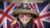 A royal fan, Sally Scott, poses on the Mall outside Buckingham Palace ahead of the Coronation of Britain's King Charles and Camilla, Queen Consort, in London, May 4, 2023. 