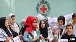 FILE - Palestinians gather for a vigil outside the offices of the International Committee of the Red Cross in Beirut on October 11, 2023, in support of the Palestinians in Gaza. (Photo by ANWAR AMRO / AFP)