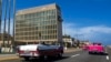 FILE - Tourists in classic cars pass the U.S. Embassy in Havana, Cuba, Oct. 3, 2017. Brain injuries known as the “Havana Syndrome” were first reported by some American diplomats who were posted in Cuba.