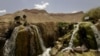 FILE - An Afghan man performs ablution before prayers at Band-E-amir in Bamiyan, Afghanistan, Aug. 31, 2005. Unknown gunmen killed four people May 17, 2024, in Bamiyan's central market, Taliban authorities said.