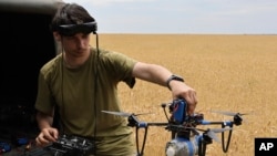 FILE - A Ukrainian serviceman operates a drone on the front line in Zaporizhzhia region, Ukraine, June 14, 2024.
