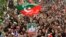 Pakistan Tehreek-e-Insaf (PTI) party supporters hold portraits of former prime minister Imran Khan, as they protest against the alleged skewing in country's national election, in Peshawar, March 10, 2024. 