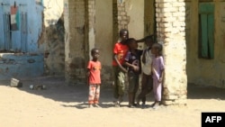 FILE - Displaced Sudanese children stand in the courtyard of a school where their families took refuge near Gadaref, Sudan, on March 6, 2024.