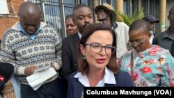 Tatiana Aleshina, who court papers said was a Russian investor, talks to reporters on Feb. 27, 2024.